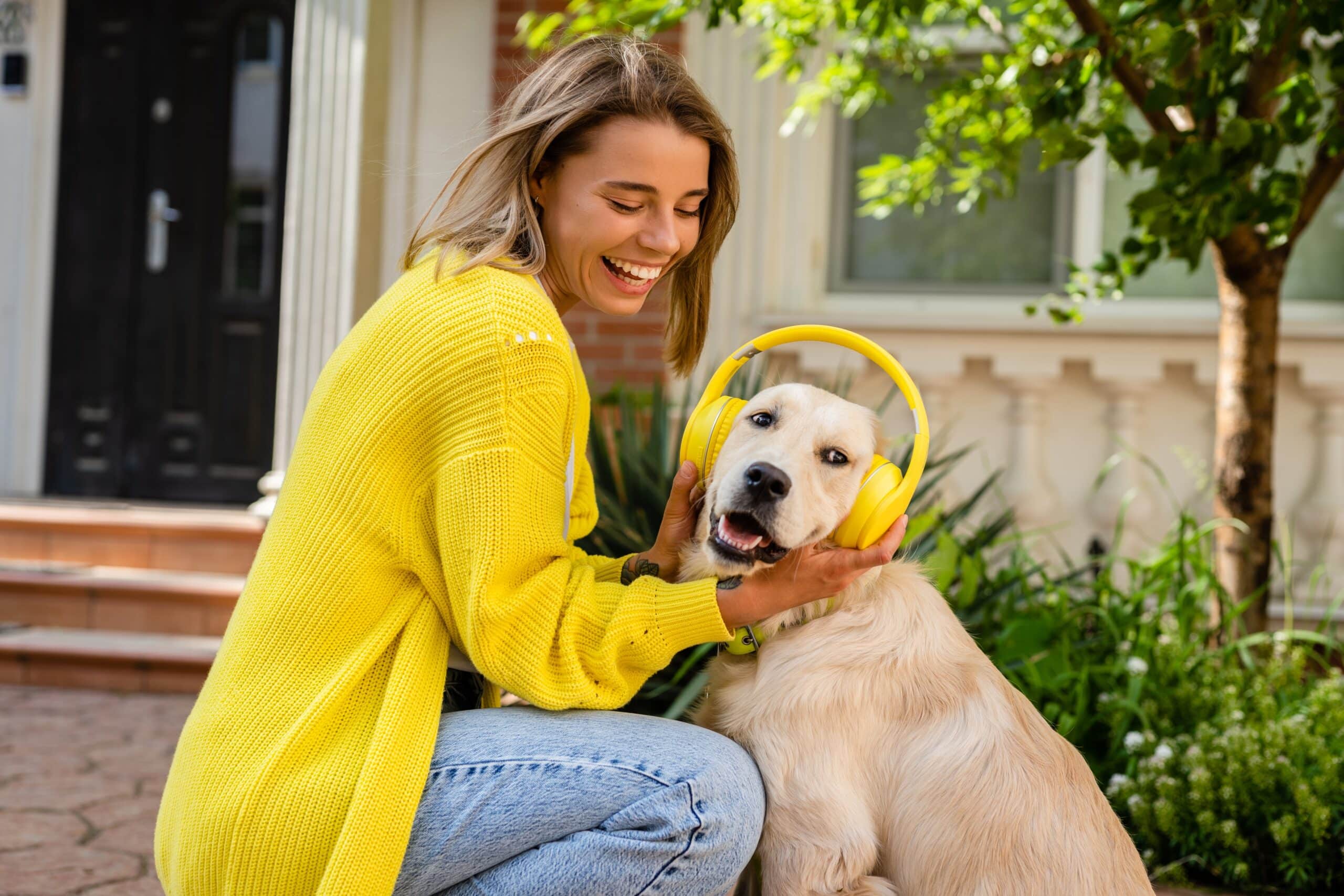 Happy,Smiling,Woman,Listening,To,Music,In,Headphones,In,Yellow